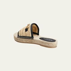 Tod's woven raffia espadrille sandals with leather trim and metal logo strap accent Flat braided-jute heel Open toe Slide style Rubber outsole Lining: Polyester Made in Italy Luxury Straw Sandals With Woven Sole, Designer Straw Open Toe Sandals, Designer Beach Sandals With Textured Sole, Designer Open Toe Straw Sandals, Designer Sandals With Woven Straw Sole, Beach Espadrilles With Woven Leather And Straw Material, Beach Espadrilles With Woven Leather And Straw, Designer Leather Espadrilles For Vacation, Chic Natural Color Espadrilles With Woven Leather