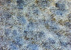 an up - close view of the texture of fabric with blue and yellow colors on it