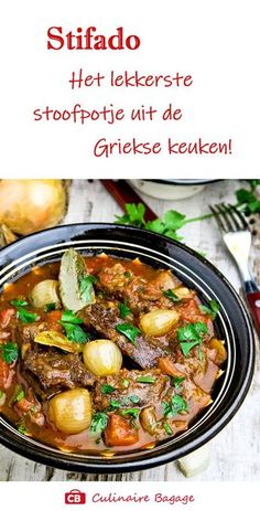 a bowl filled with meat and potatoes on top of a table