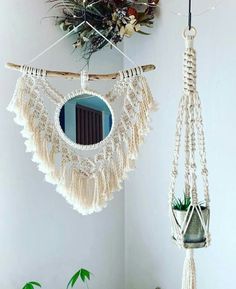 two macrame hangings with plants in them and a mirror on the wall