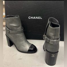 *Nwb Never Worn, 100% Authentic* Chanel Dark Silver/Black Short Boots With A Patent Leather Cap-Toe. This Has A Block Heel Measuring 3.5”, Featuring A Buckle Closure, And The Chanel Logo On The Back Of The Heel And On The Cap-Toe Part. Made In Italy. ***I Am Open To Offers Size: 38 / 8 In U.S. Color: Pewter/Grey & Black Elegant Gray Winter Boots, Gray Round Toe Formal Boots, Designer High Heel Boots For Fall, Gray Round Toe Boots For Formal Occasions, Luxury Ankle-high Boots For Fall, Gray Formal Boots With Round Toe, Gray Leather Boots For Fall, Luxury Fall Ankle Heeled Boots, Gray Formal Boots For Fall