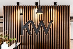 a wooden wall with the letters w and m on it in front of a kitchen counter