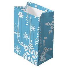 a blue shopping bag with white snowflakes on it