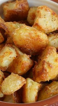 a bowl filled with fried potatoes sitting on top of a table