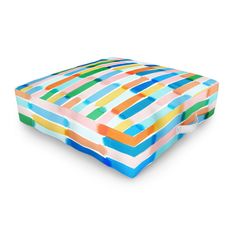 a multicolored square shaped pillow on a white background