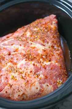 the meat in the slow cooker is covered with seasoning