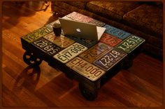 a coffee table made out of license plates with a laptop on it and the words back road treasures