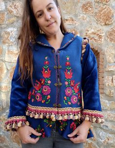 This gorgeous jacket started with a vintage hand embroidered Hungarian felt vest, completely handmade. We have embellished it by adding sleeves, lining and adding vintage trims. We also attached a peplum to make the jacket longer and more fun. We added beautiful brass hooks to close the jacket. The jacket is made of a deep blue wool (100% natural wool) the lining is a very sweet blue taffeta. Although it is vintage, the vest had clearly never been used.  It is of a nice weight, perfect for Fall Traditional Fitted Outerwear With Embroidered Sleeves, Blue Long Sleeve Outerwear With Intricate Embroidery, Embroidered Long Sleeve Outerwear For Costume, Embroidered Costume Outerwear For Fall, Fitted Festival Outerwear With Intricate Embroidery, Folk Style Blue Outerwear For Fall, Vintage Embroidered Outerwear For Costume, Blue Folk Style Outerwear For Fall, Fitted Folk Style Embroidered Outerwear