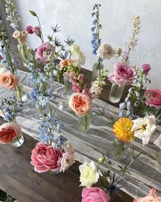 several vases filled with different colored flowers