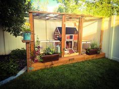 an outdoor garden area with potted plants and a dog house in the back yard