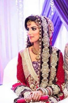 a bride sitting on the bed in her wedding outfit