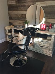 a chair that is sitting in front of a desk with a mirror on top of it