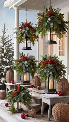 christmas decorations hanging from the ceiling in front of a porch with candles and greenery