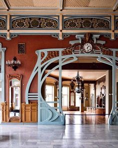 an ornate entry way with a clock on the wall