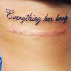 a woman's stomach with the words everything has beauty written on her lower back