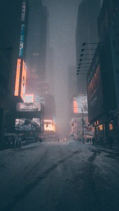 a city street at night in the snow with buildings and billboards on both sides