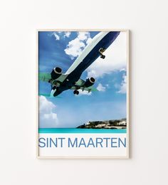 an airplane is flying over the ocean on a poster