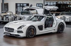 the mercedes sls amg roadster is parked in front of several other cars