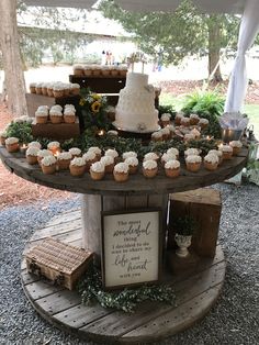 a table topped with cupcakes under a tent