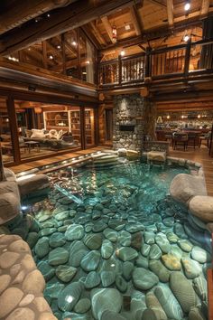 an indoor swimming pool with rocks in the middle and water running down it's sides