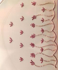 several pieces of silver and pink beaded hair pins on a white plate with purple trim