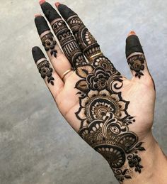 a hand with henna tattoos on it