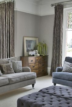 a living room filled with furniture and windows