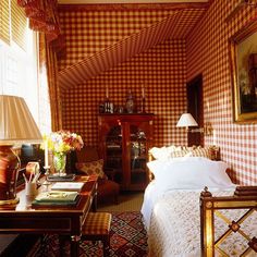 a bedroom with red and white checkered walls