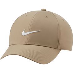 the nike golf hat is tan and has a white swooish logo on it