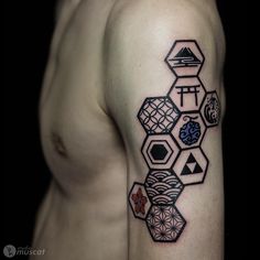 a man with a tattoo on his arm that has geometric shapes and symbols all over it