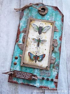 an altered picture with butterflies on it and a tag hanging from the side, attached to a wooden wall