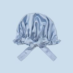 a blue satin bonnet with a bow on the side