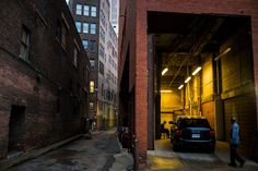 an alley way with cars parked in it