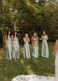 the bride and her bridesmaids are standing outside