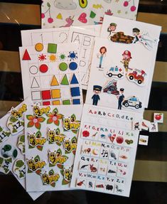 several children's stickers are on display in a store window, including one with letters and numbers