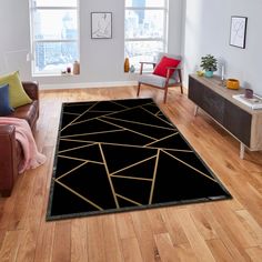 a black area rug with gold lines on it in a living room next to a couch