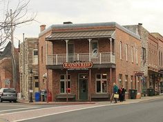 an old brick building on the corner of a street