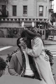 black and white photograph of two people sitting on a bench