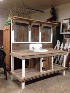 an old fashioned sink and cabinet in a room with other items on the wall behind it