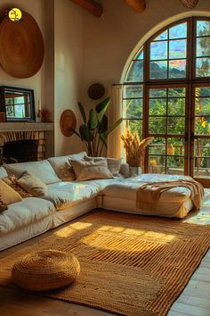 a living room filled with furniture and large windows