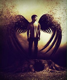 a man is standing in front of an angel's wings