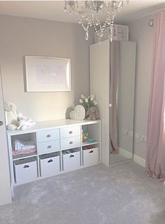 a baby's room with pink and white decor