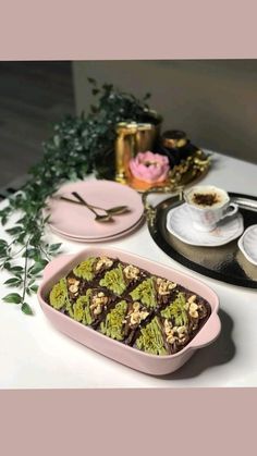 a table topped with plates and trays filled with dessert items on top of it