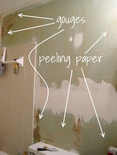 the bathroom wall is being painted with white paint and features arrows pointing in different directions