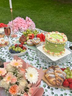 a table topped with lots of different types of cakes and desserts on top of it