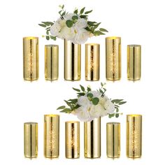 gold vases filled with white flowers and greenery