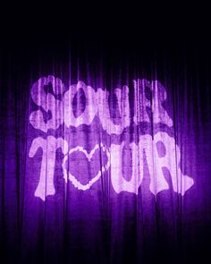 the words sound tour are projected on a purple curtain