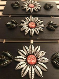 several decorative items are displayed on black boards with red and white designs in the center