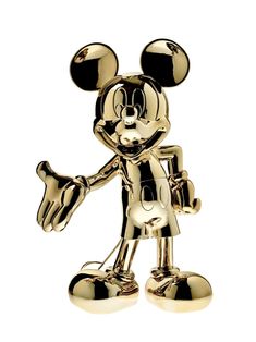 a gold mickey mouse figurine is shown in front of a white background,