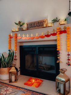 a fireplace decorated with orange garland and candles